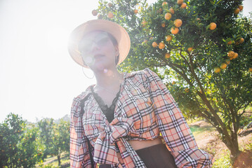 Cute thai girl travel to orange farm in Chiang Mai, Thailand.