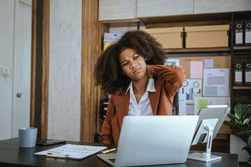 Tired african american business woman working with audit, balance sheet, investing activities, safety stock, net loss, business risks, accumulated depreciation, factory overhead, accrued expense