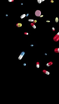 Pills and capsules falling. Loop section from 10:00-20:00. With luma matte. Vertical video. Medicine, medical, pharmaceuticals.