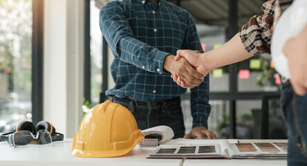 Engineer and contractor shaking hands success of the project work together