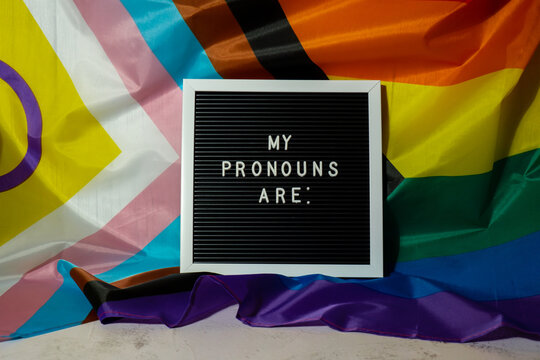 MY PRONOUNS ARE text Neo pronouns concept on Rainbow flag background gender pronouns. Non-binary people rights transgenders. Lgbtq community support assume my gender, respect pronouns tolerance equal