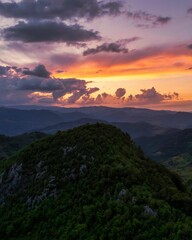 Beautiful vertical view of a sunset over the high hills