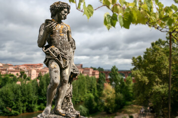 Selective of a deity Dionysus sculpture in greenery