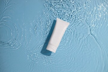 White toothpaste tube isolated on a light pastel background