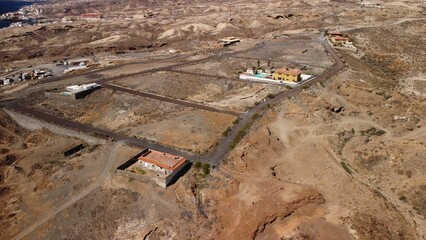 Aerial shot of a building development site with multiple buildings near the coast