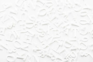 Closeup of white letters on white background