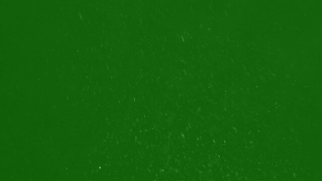 cold snow hovering on the green screen background