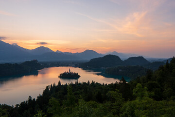 Fototapeta na wymiar Lake Bled, Slovenia. Sunrise at Lake Bled with famous Bled Island and historic Bled Castle in the background.