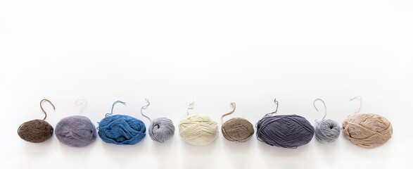 Banner from skeins of different types of woolen yarn for knitting. Thread ends of different...