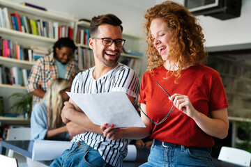 Group of young multi-ethnic startup business team collaborating on project in modern office