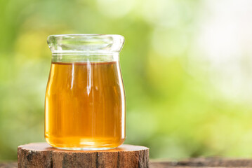 Apple cider vinegar on nature background.