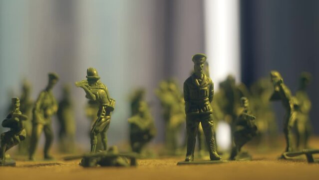 Tracking shot of toy soldier company. Violence war resistance and peace without armored invasion