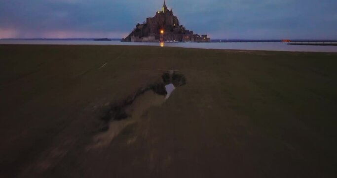 Fly over Mont Saint-Michel, one of Europe's most unforgettable sights. Located in the bay where Normandy and Brittany merge, the island attracts the attention of tourists from all over the world
