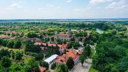 Drone shot of the cityscape in Ecka Village with trees and blue cloudy sky