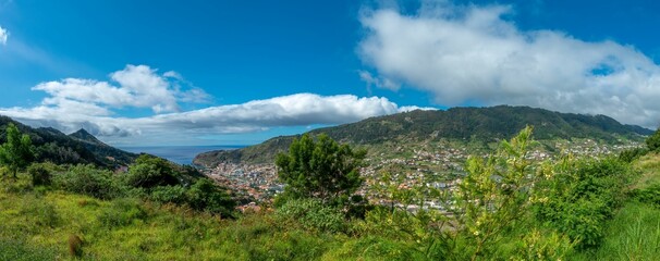Fototapeta na wymiar Panoramic view of mountain Madeira with green plants and a cloudy sky