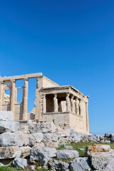 Fototapeta na wymiar Ancient temple Parthenon in Acropolis Athens Greece on a bright blue sky background. The best travel destinations. Vertical photo.