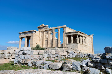 The ancient Parthenon temple in the Acropolis of Athens, Greece on a bright blue background....