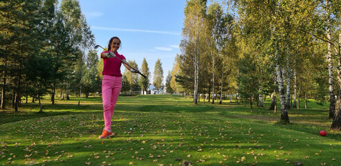 Professional golfer holds golf club on field concept