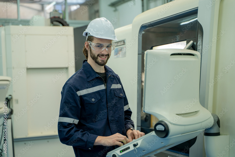 Fototapete Engineer operating cnc machine in control panel at factory,Industry 4.0 concept.