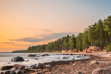 Veczemju cliffs on Baltic sea shore in Latvia during the sunset. Long exposure photography. - obrazy, fototapety, plakaty