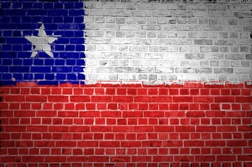 Closeup of the Chile flag painted on a brick wall in an urban location