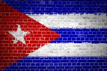 Closeup of the Cuba flag painted on a brick wall in an urban location