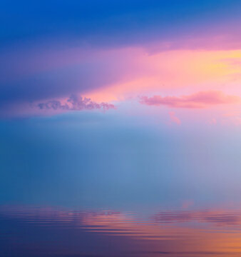 peacful sunrise pink cloudy sky over calm water; Abstract Background of colorful morning sky