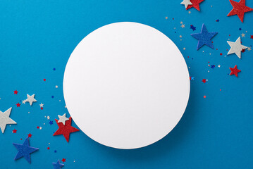 Top view arrangement of party essentials: glitter stars and confetti, symbolizing USA's Independence Day. Presented on a blue backdrop with space for text or advert within an empty circle