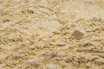 Fototapeta na wymiar Pile of garlic powder as background, spice or seasoning as background. Ground or sifted garlic powder. Indian spice