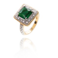 Vintage gold ring with an big emerald stone and diamonds . DOF. Selective focus. Jewellery isolated...