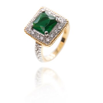 Vintage gold ring with an big emerald stone and diamonds . DOF. Selective focus. Jewellery isolated on white 