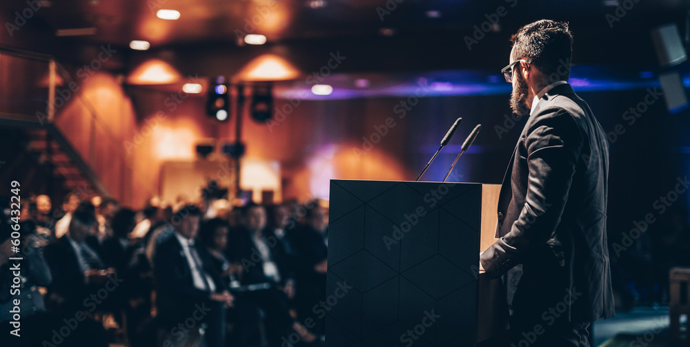 Wall mural Speaker giving a talk on corporate business conference. Unrecognizable people in audience at conference hall. Business and Entrepreneurship event.