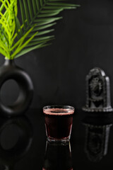 Drink on Black Deep Background with Leaf Decoration