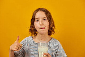 Pretty teen girl, child with a fresh glass of milk