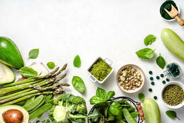 Vegetarian healthy green food on white background. Products for vegans and vegetarians containing vegetable protein. Green peas, beans, mung beans, broccoli, zucchini, avocados, matcha, spinach. - 606437427