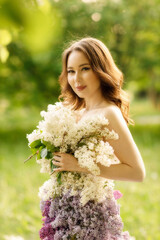 portrait of a girl in a lilac dress lying on the grass, taken at sunset