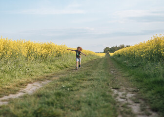 Child playing in the rapeseed field