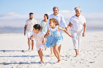Holiday, happy and big family running on the beach for playing and bonding on a weekend trip....