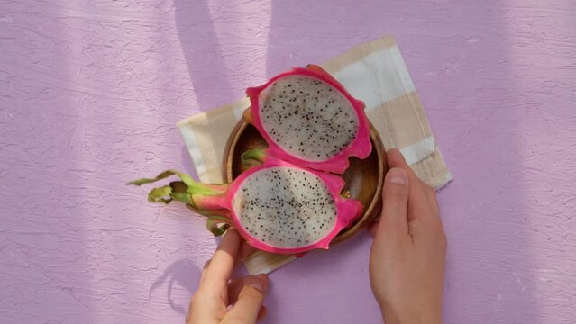 Organic dragon fruit on a pink background, creative summer food concept. Flat lay