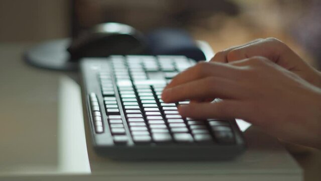 Man hands are typing on a computer keyboard working from home, a freelancer. Internet and social networks. Selective focus