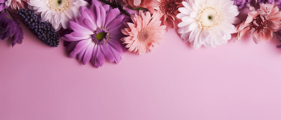 Top view pink and purple flowers composition over pastel background copy space on left