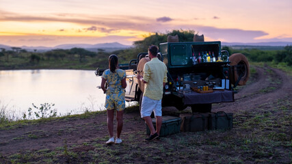 Asian women and European men on safari game drive in South Africa Kruger national park. a couple of...