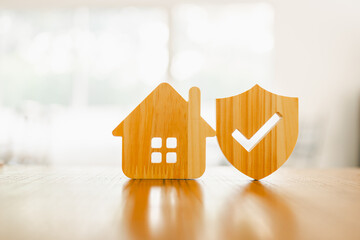  Wooden house model and real estate insurance ideas, and small shield icon. Housing insurance...