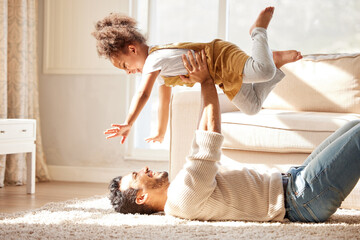 Dad, lying and floor with girl, airplane and happiness with playing games, smile or bonding in...