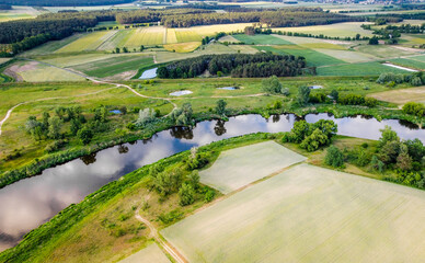 Panorama of the Greater Poland Voivodeship. Top view of fields meadows river and woods. Drone view....
