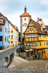 Fototapeta na wymiar Colourful street of Rothenburg ob der Tauber, Plönlein, the Franconia region of Bavaria, Germany. Medieval old town. The most romantic town in Germany.