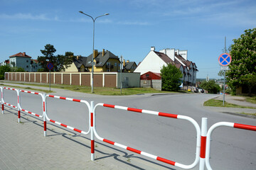 Railings separating the road from the pavement , view of the down exit