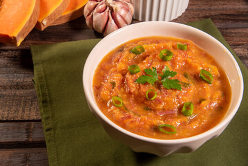 Homemade pumpkin cream, accompanied by spices. pumpkin broth