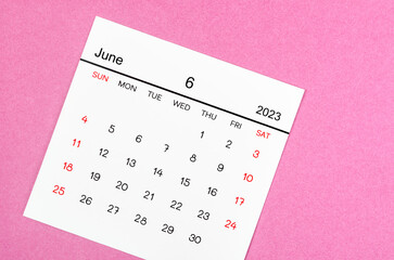 Obraz na płótnie Canvas The June 2023 Monthly calendar for 2023 year on pink background.