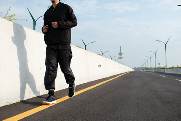 Man runner feet running on road, Jogging at outdoors. Man running for exercise.